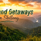 Text reads 11 Best Weekend Getaways from Shillong over a scenic view of a lush green valley with a winding river and sunset sky, mountains in the distance, and vibrant clouds—perfectly capturing the allure of unforgettable Weekend Getaways from Shillong.